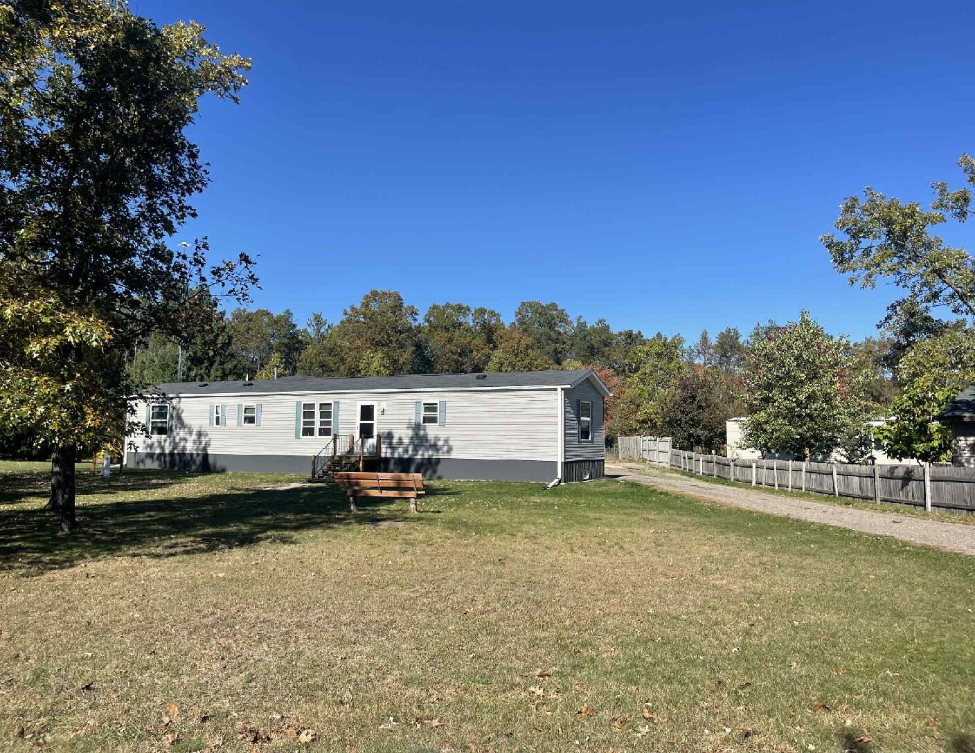 front yard with trees gone and drive